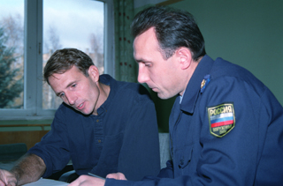 Gagarin Cosmonaut Training Center in Star CityP Linenger sits at a table next to a Russian trainer